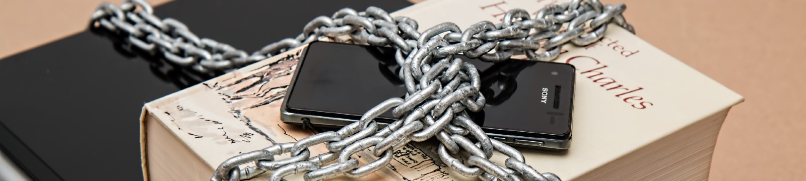chain covering a mobile device and a book