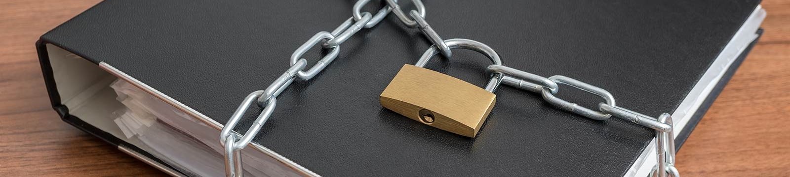 a chain and pad lock around a black binder